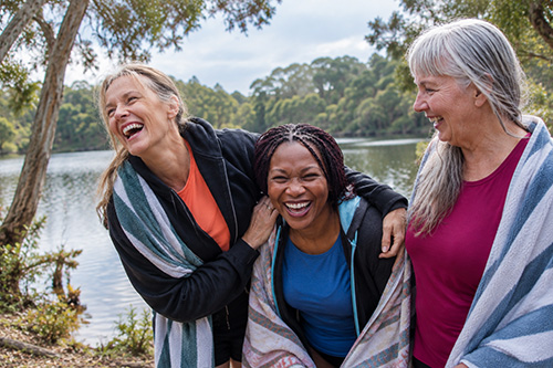 Three women enjoying time together outdoors by Lake Ainsworth in Lennox Head.